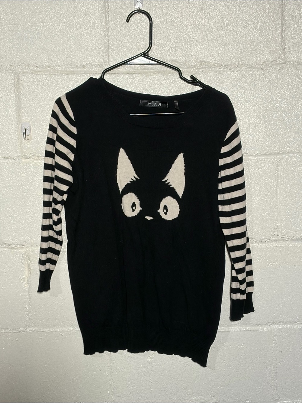 Women's Black Crewneck Sweater with Cream Cat Graphic and Striped Sleeves